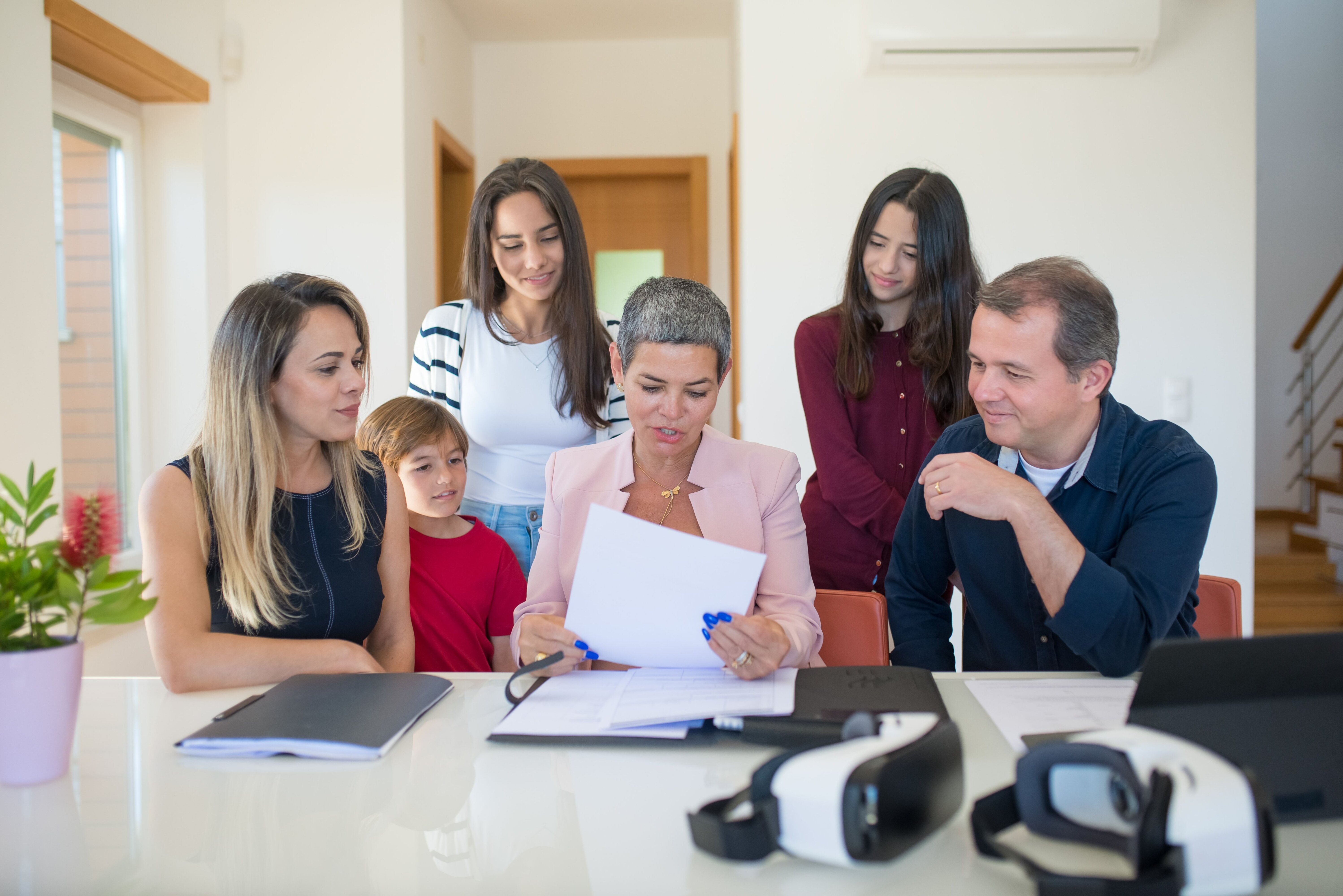 Family discussing paperwork together at home