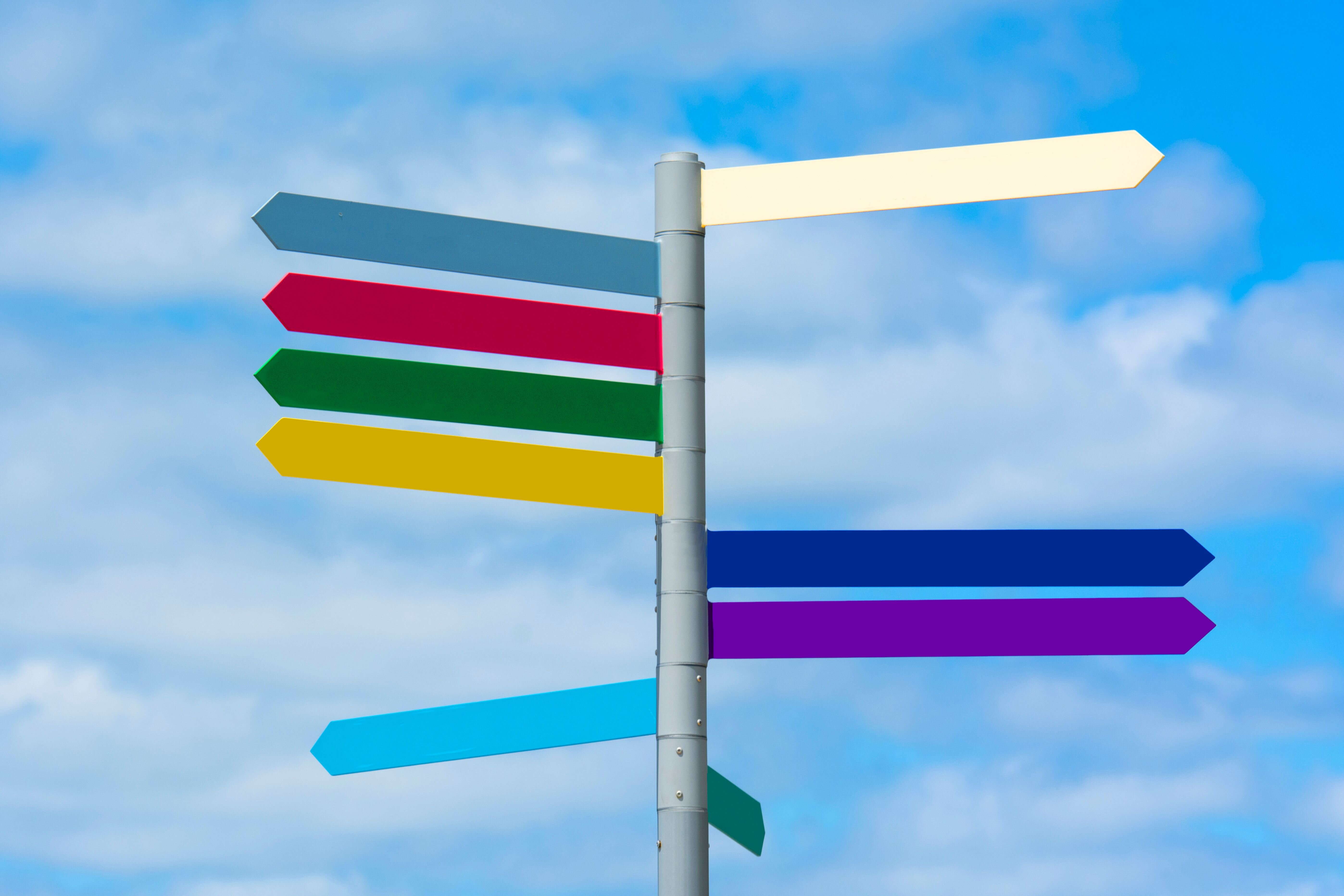 Multiple road signs pointing different directions, representing the different options for selling a house fast