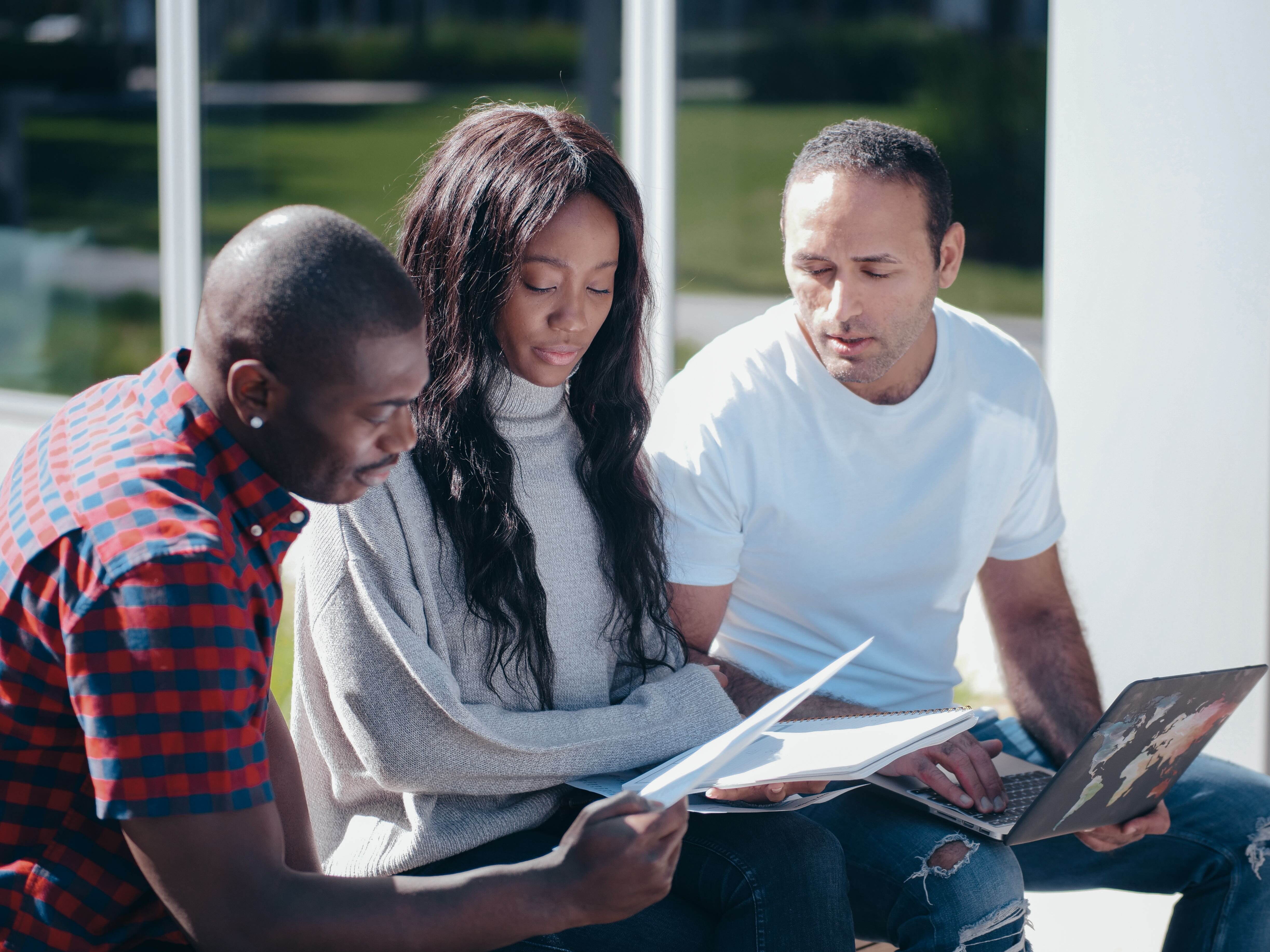 Family members sitting together reviewing paperwork, representing siblings working through selling an inherited house