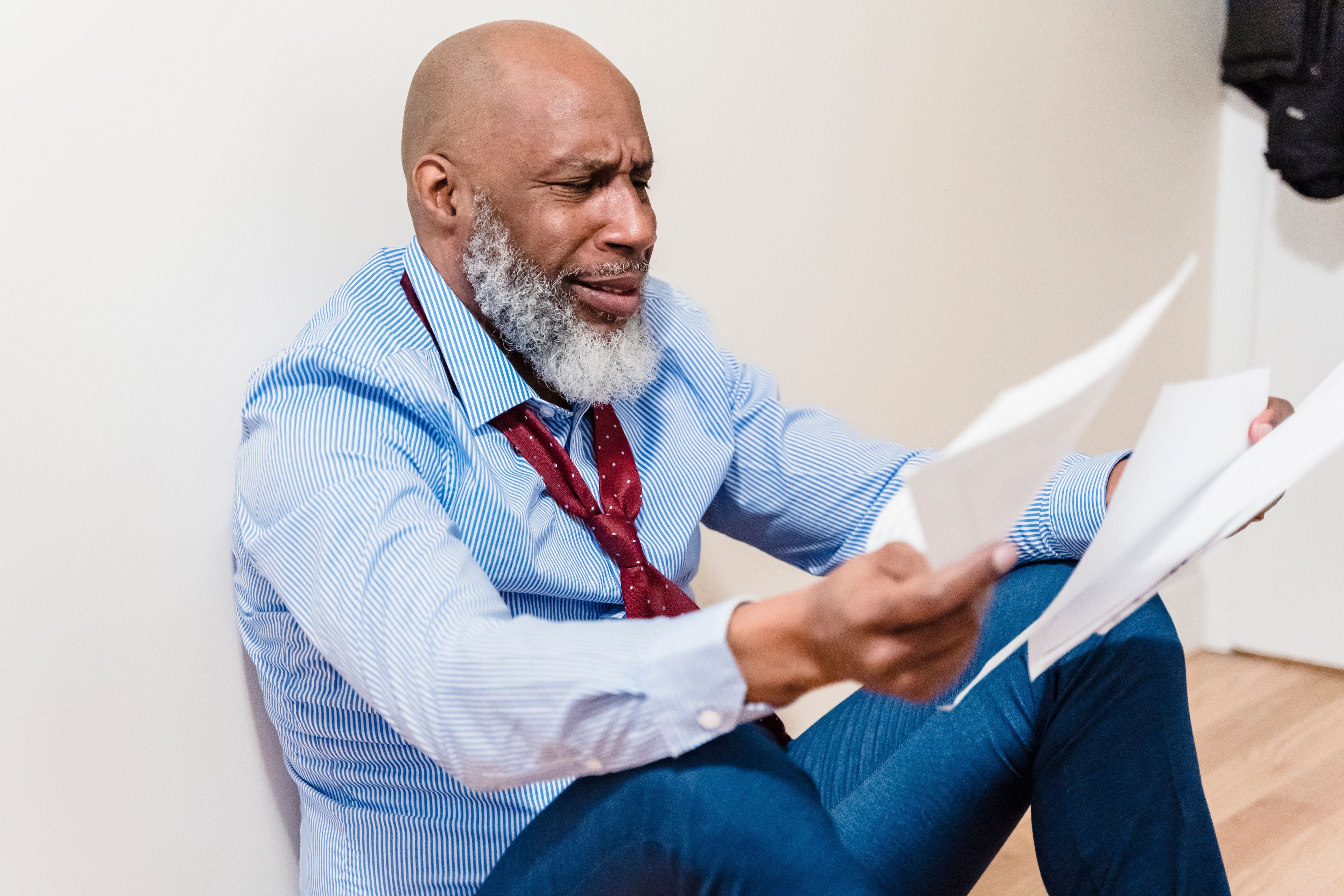 Person reading an official notice letter at home, representing receiving a pre-foreclosure notice