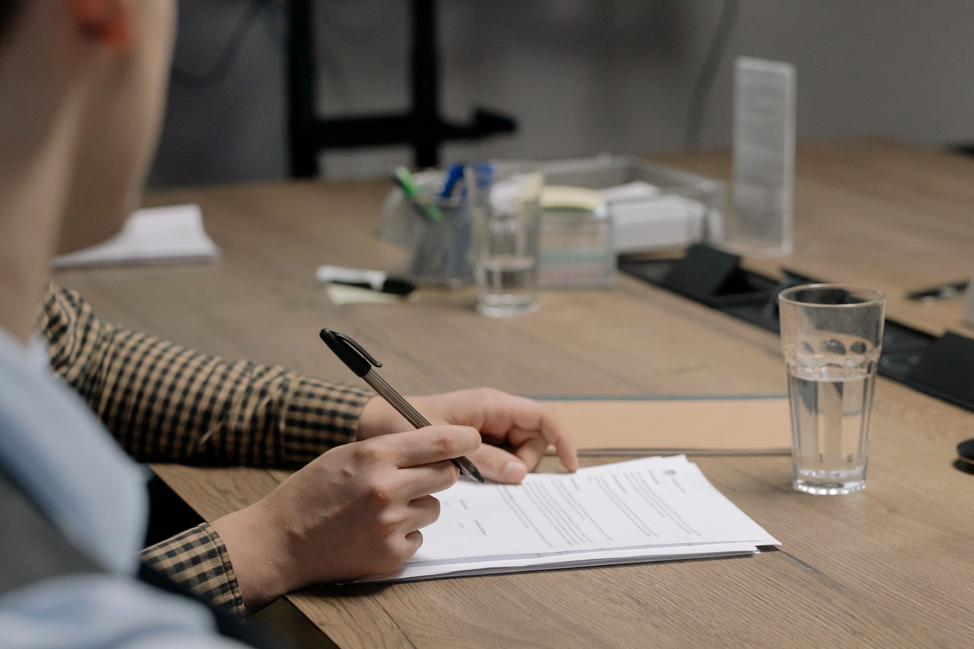 A homeowner reviewing bankruptcy and foreclosure paperwork at a kitchen table