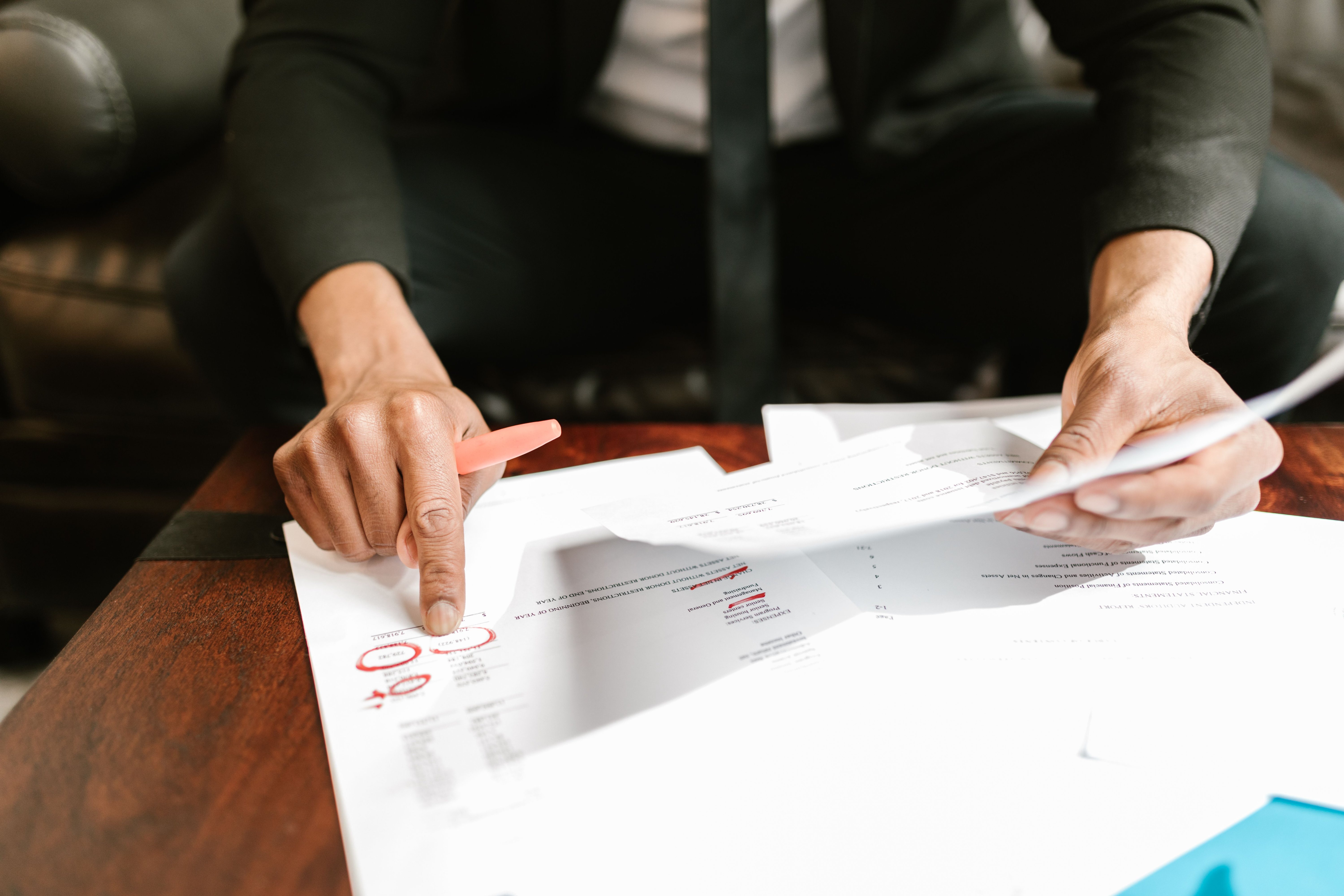 A homeowner reviewing a foreclosure notice and property tax statement side by side at a desk