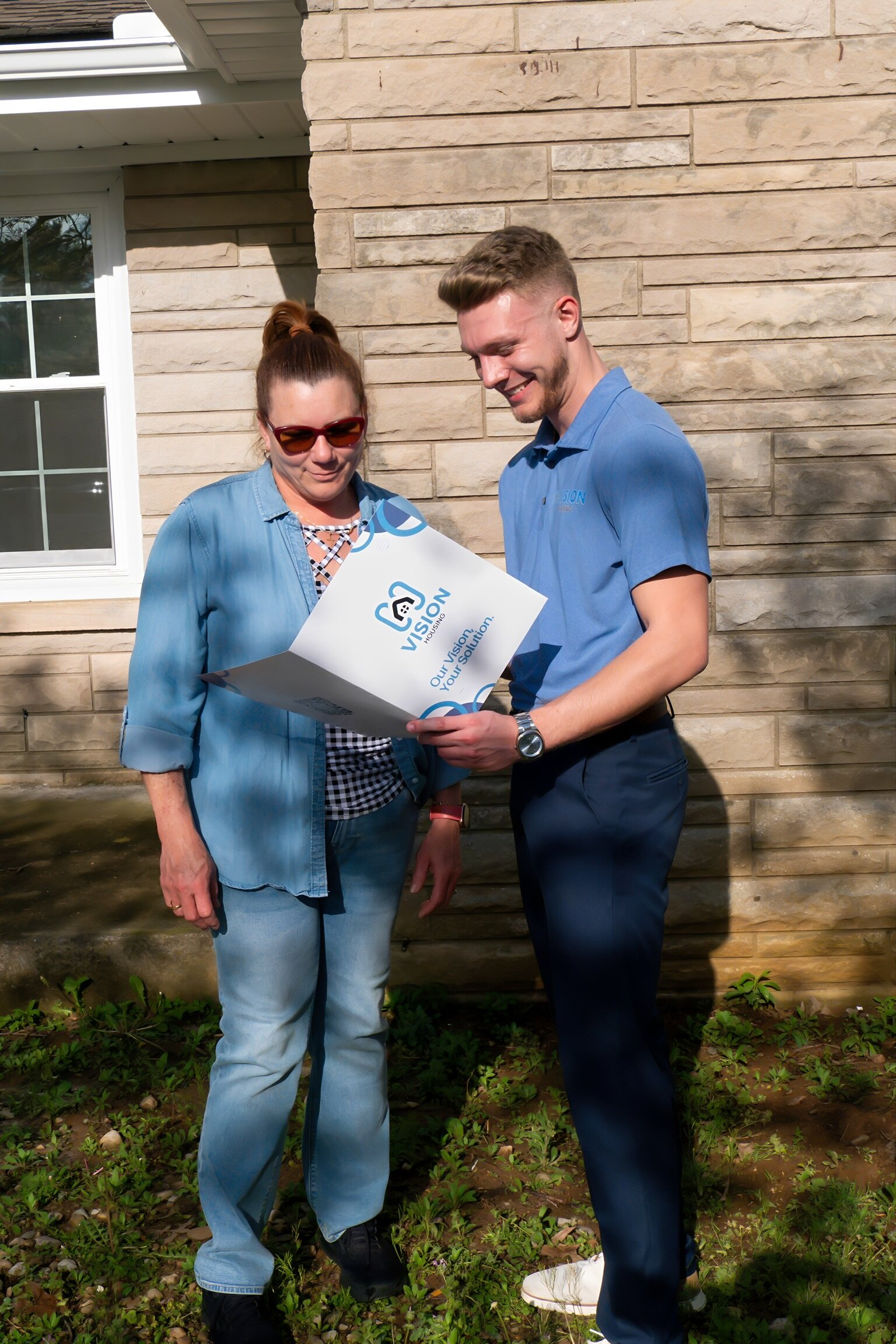 Vision Housing Team Member helping House Seller