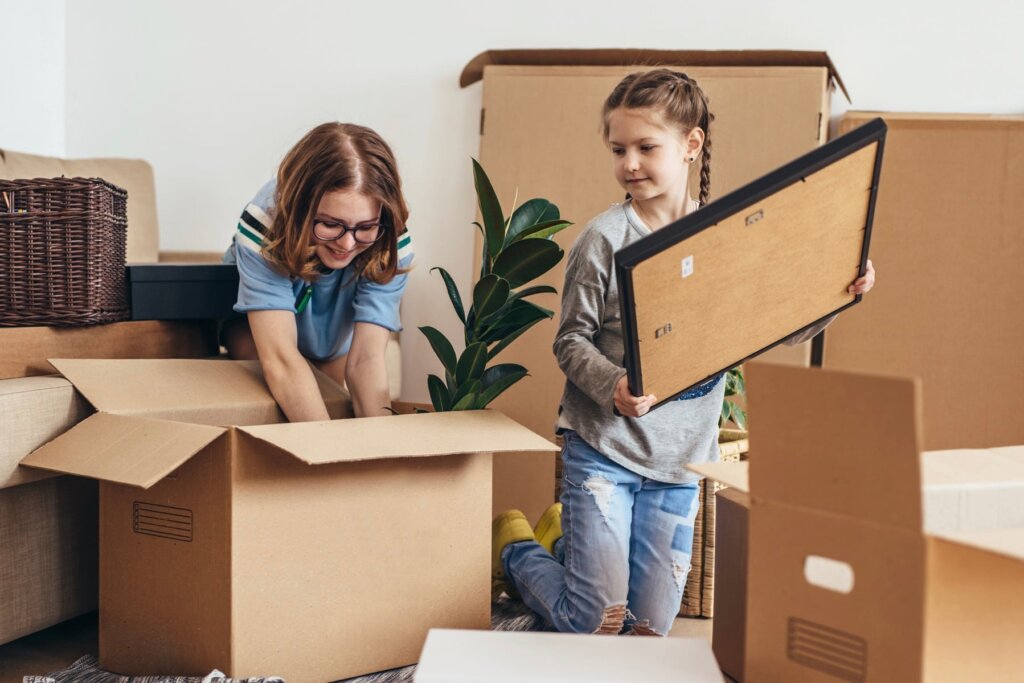 Homeowner packing moving boxes while preparing to sell a Knoxville house as-is before relocating