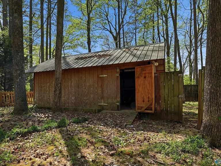 Detached backyard storage building demolition and residential property clearing services by local contractors in Huntsville, Alabama