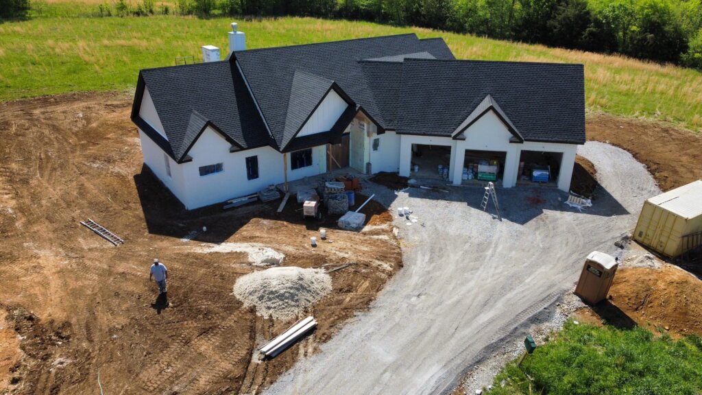 Aerial view of a custom single-story house build during the exterior completion phase by local home builders in Huntsville, Alabama