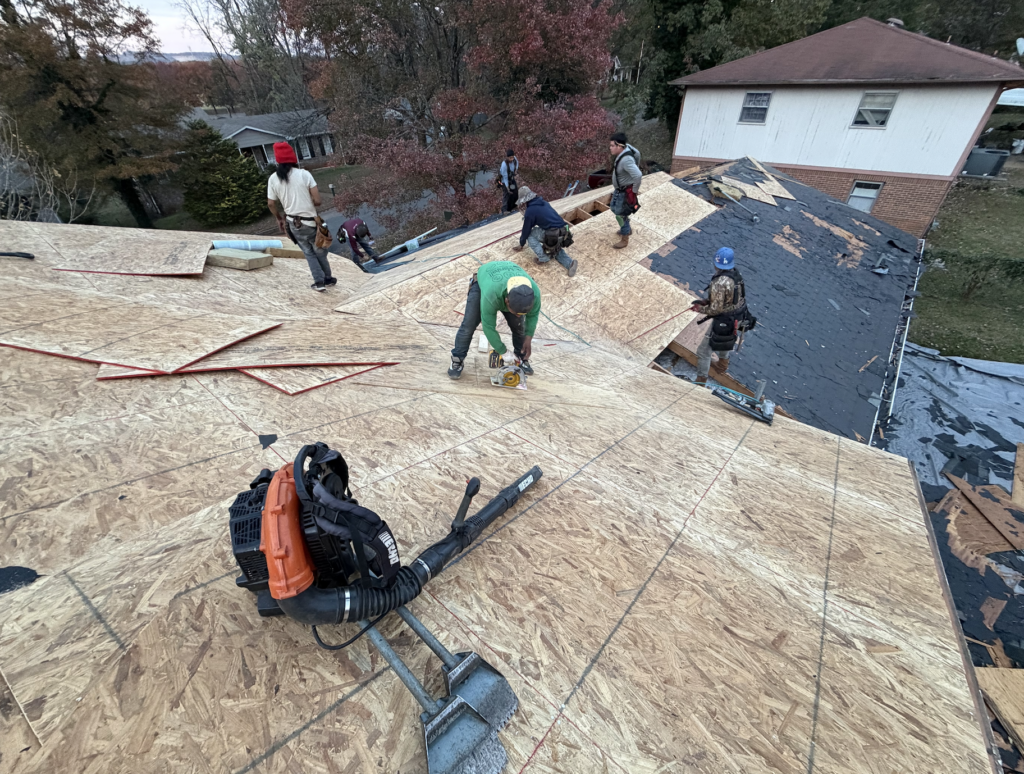 Professional Huntsville roofing contractors replacing roof decking and installing plywood sheathing on a residential home by Redstone Ridge Homes.