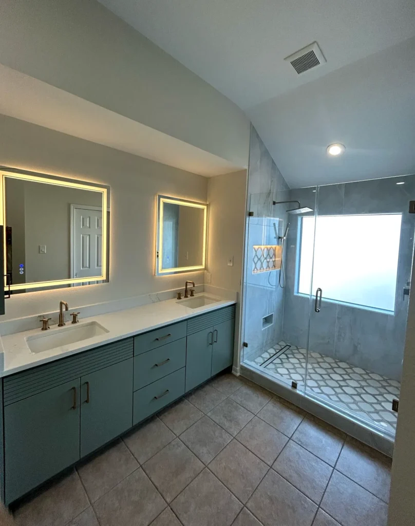 Modern bathroom remodel with double vanity, LED mirrors, and walk-in shower by Mint Construction Pros in Texas