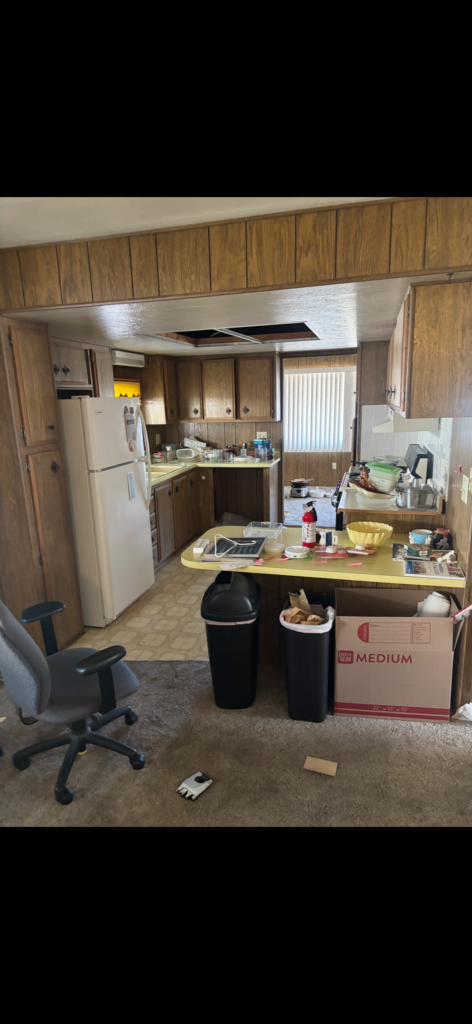 mobile home littered with debris