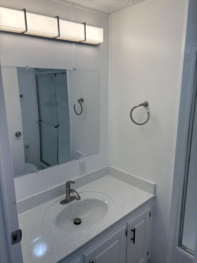 Finished bathroom after the shower stall was professionally reglazed and other improvements were completed.