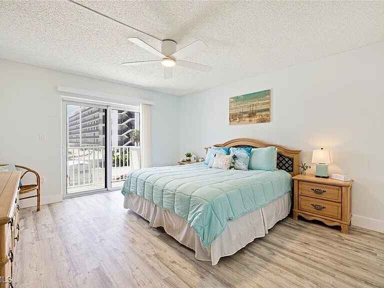 Bedroom with turquoise bedding and sliding doors