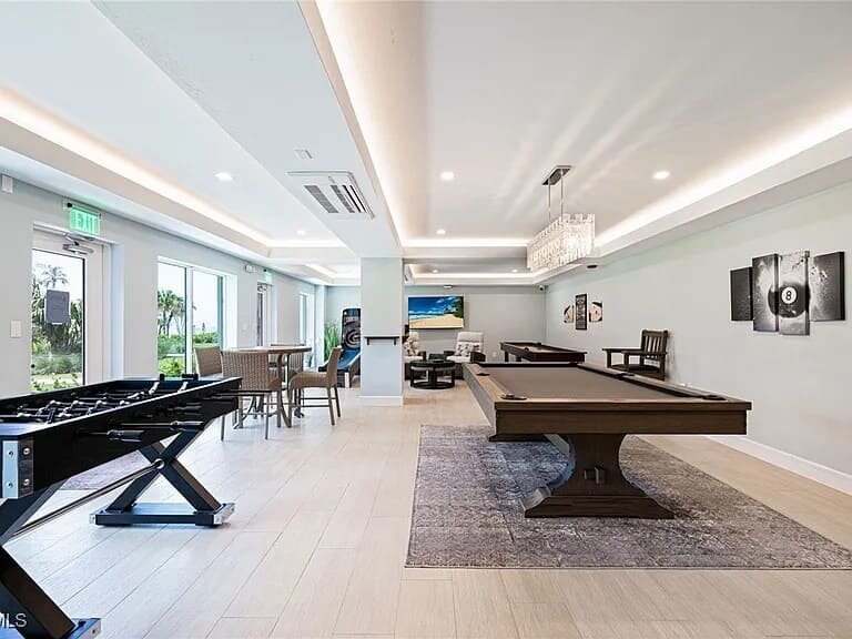Game room with a pool table and game tables