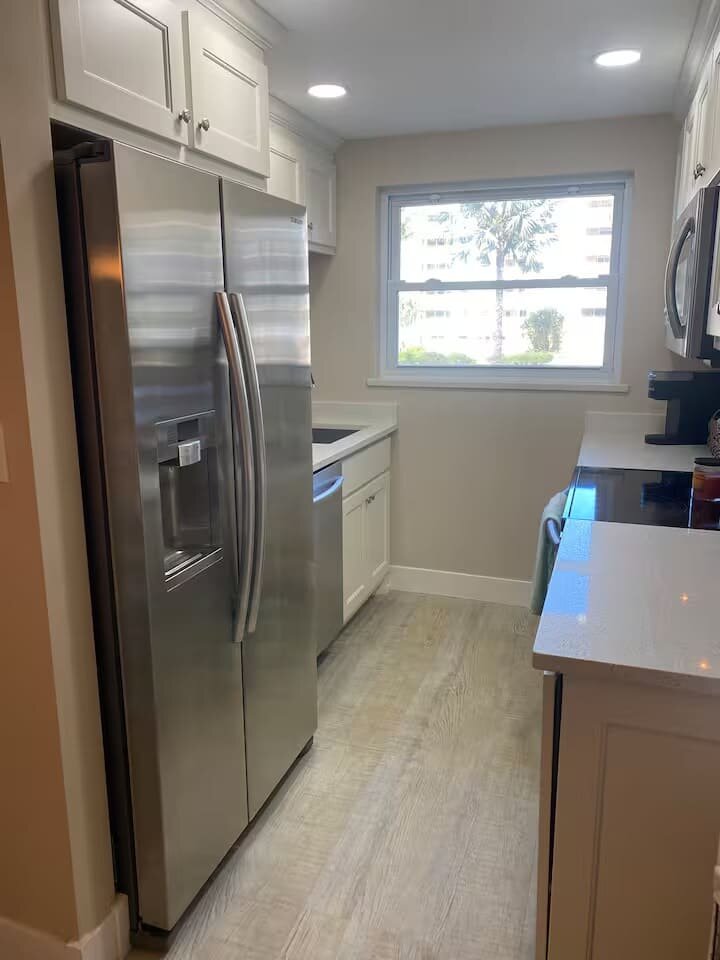 Kitchen with stainless side-by-side refrigerator
