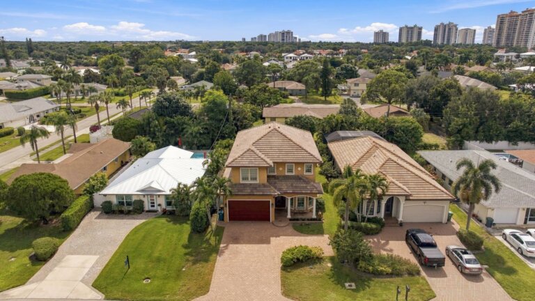 Aerial view of the home and the surrounding tree-lined Naples Park neighborhood in North Naples