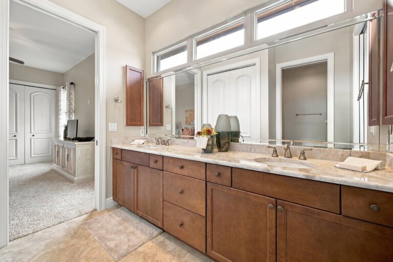 Bathroom with a double vanity, wood cabinetry and granite countertop