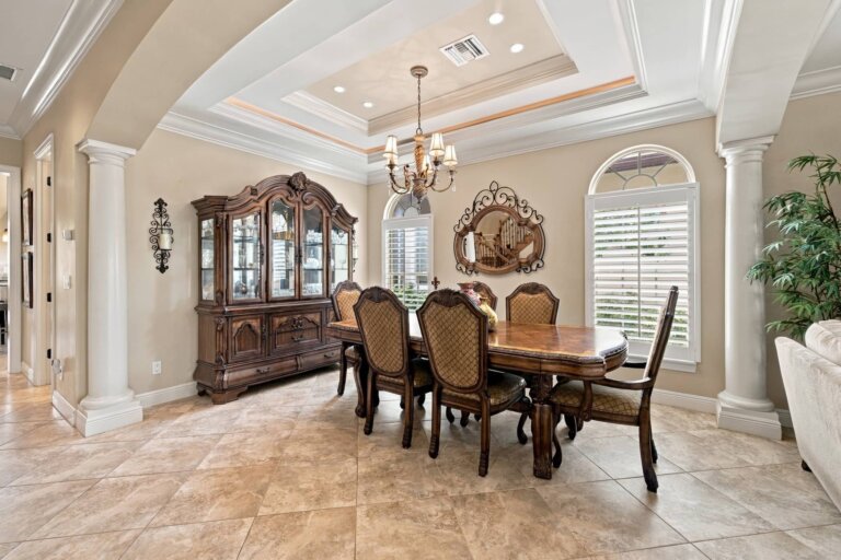 Formal dining room with a chandelier, wood dining table and china cabinet