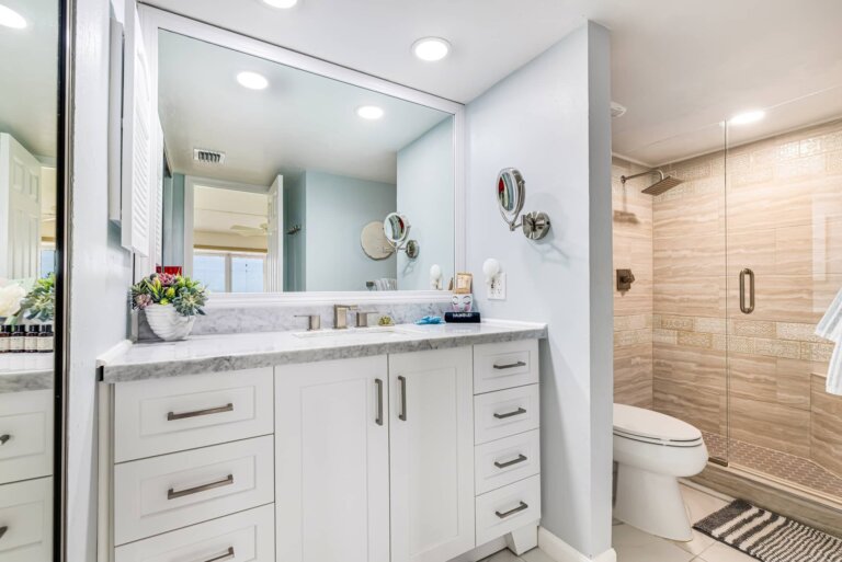 Bathroom with a white vanity and glass-enclosed shower