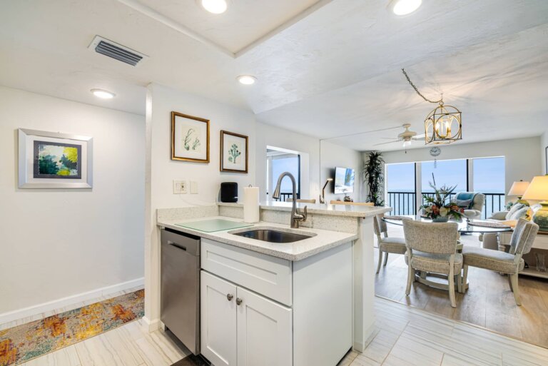 Kitchen opening to the dining area with water views beyond