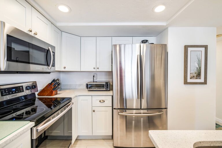 Stainless steel refrigerator, range and microwave in the kitchen