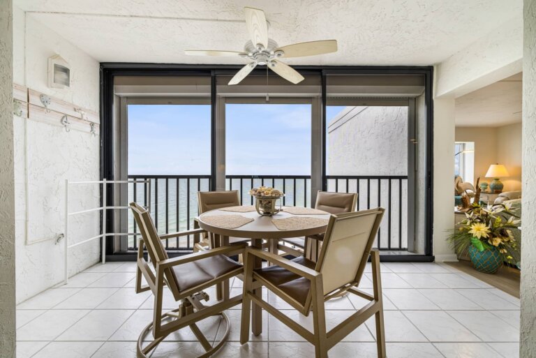 Indoor patio dining table and chairs with Gulf views