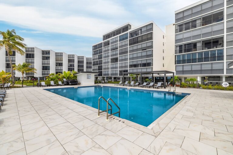 Community pool courtyard framed by the condominium buildings