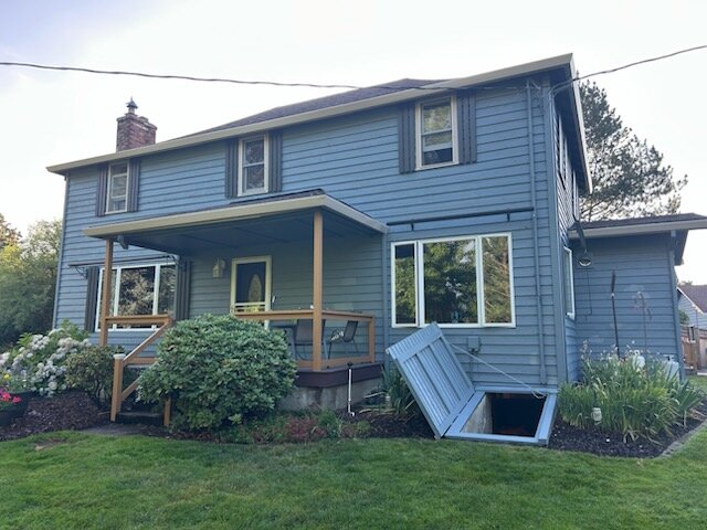 Two-story rear exterior of the Hubbard home before painting