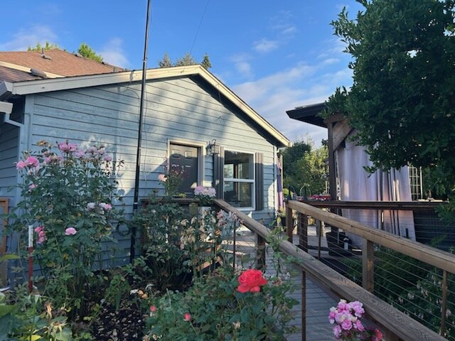 Side entry and exterior of the Hubbard home before painting