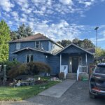 Exterior painting in progress on a two-story home in Hubbard, Oregon