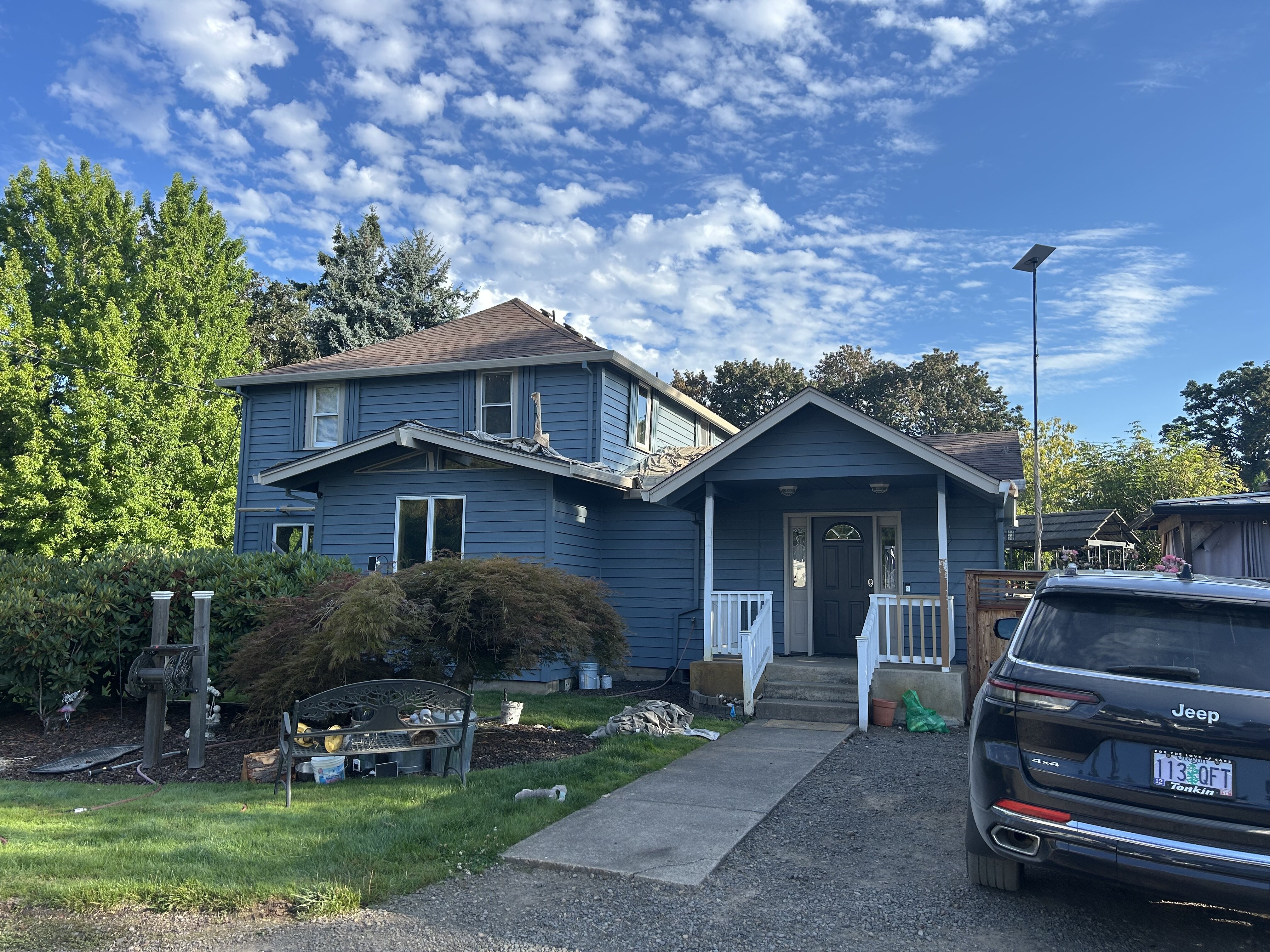 Exterior painting in progress on the front of a Hubbard Oregon home