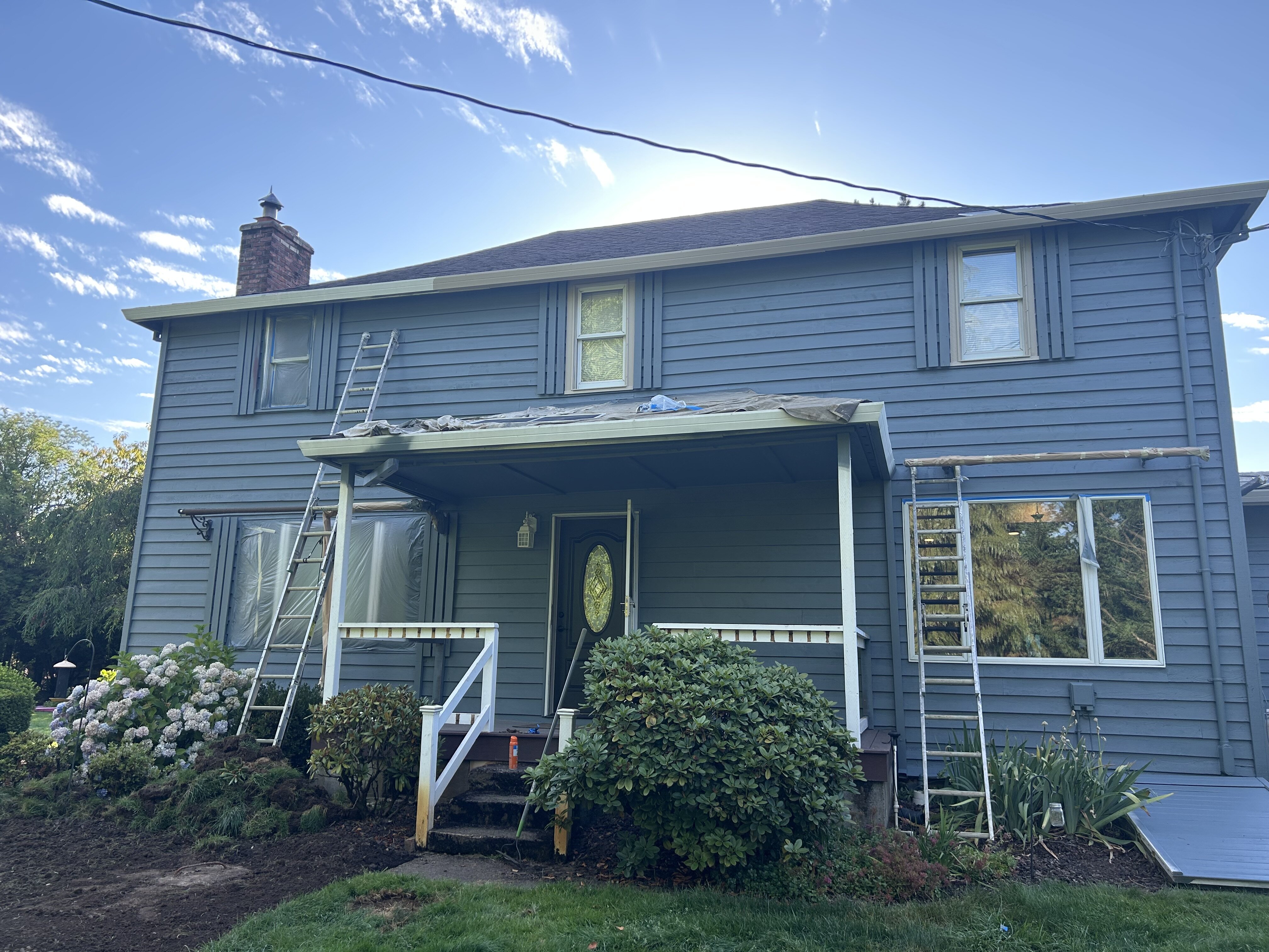 Ladders and protective masking during exterior painting in Hubbard Oregon
