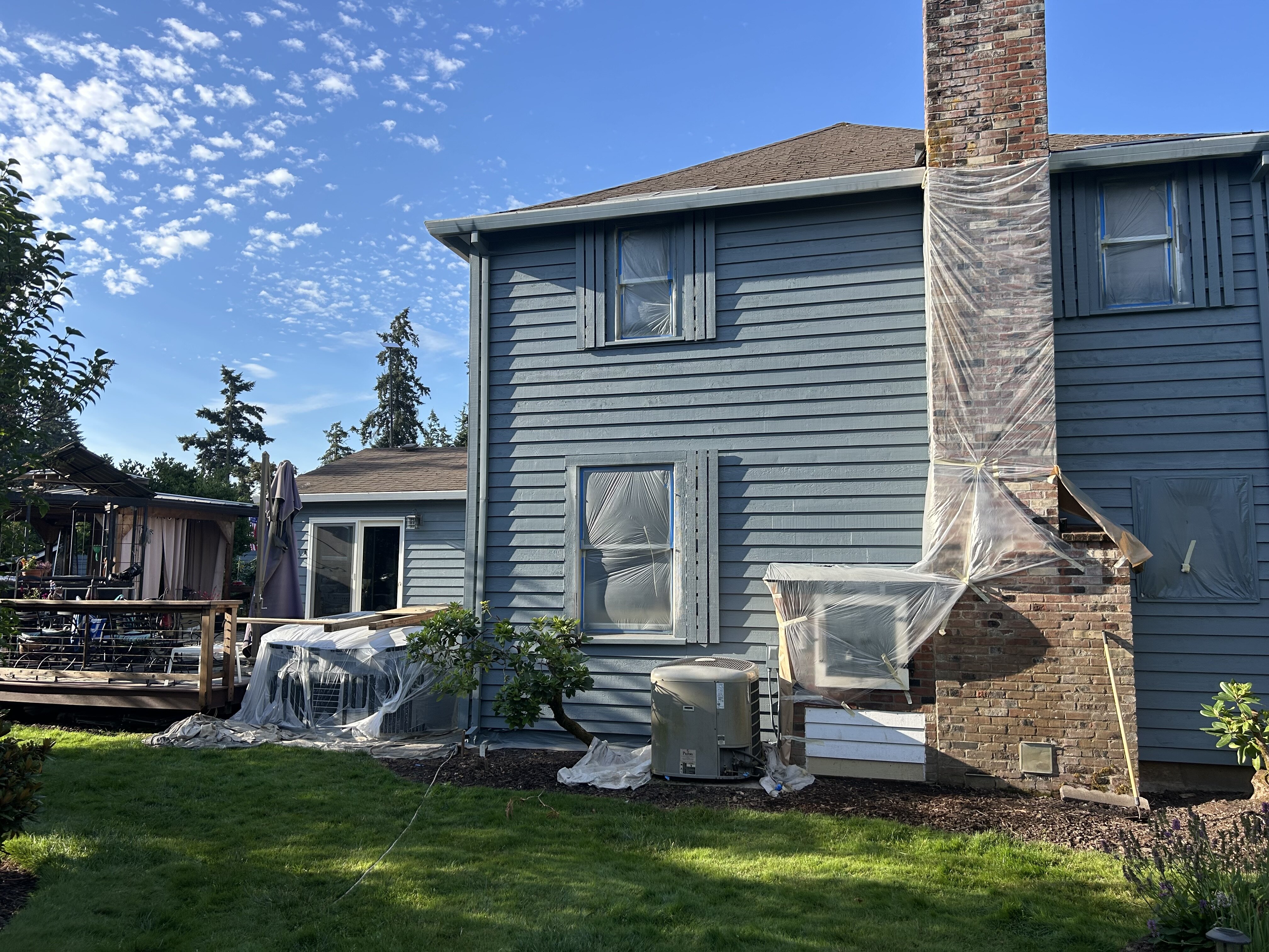 Windows and chimney protected during exterior painting work