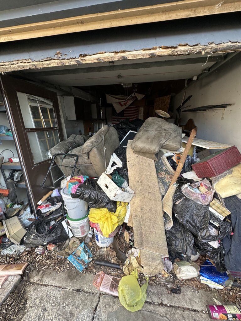 Cluttered kitchen and dining area in a Lake County home, full of belongings left behind before Greentown Home Buyers purchased it as-is