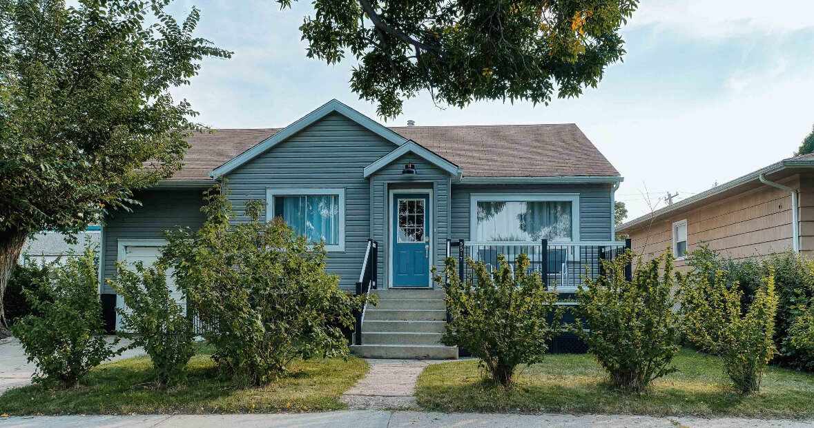 Blue-gray bungalow in Manitoba purchased for cash by SellHouseCashSask