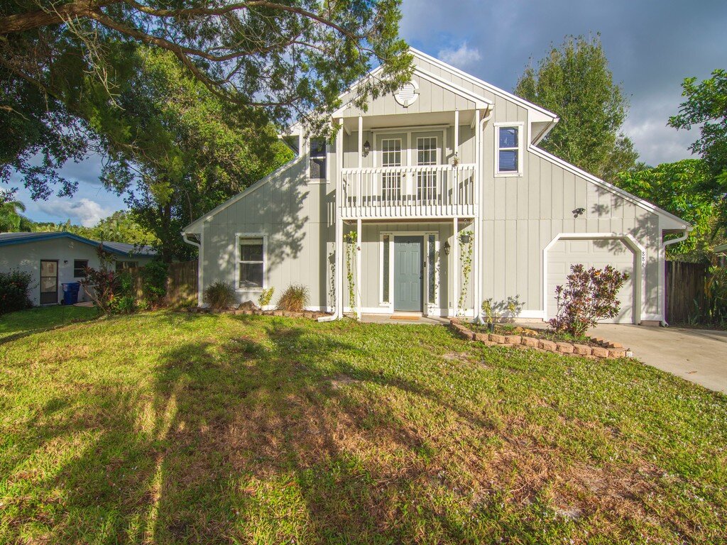 Two-story single-family home with a balcony in South Florida