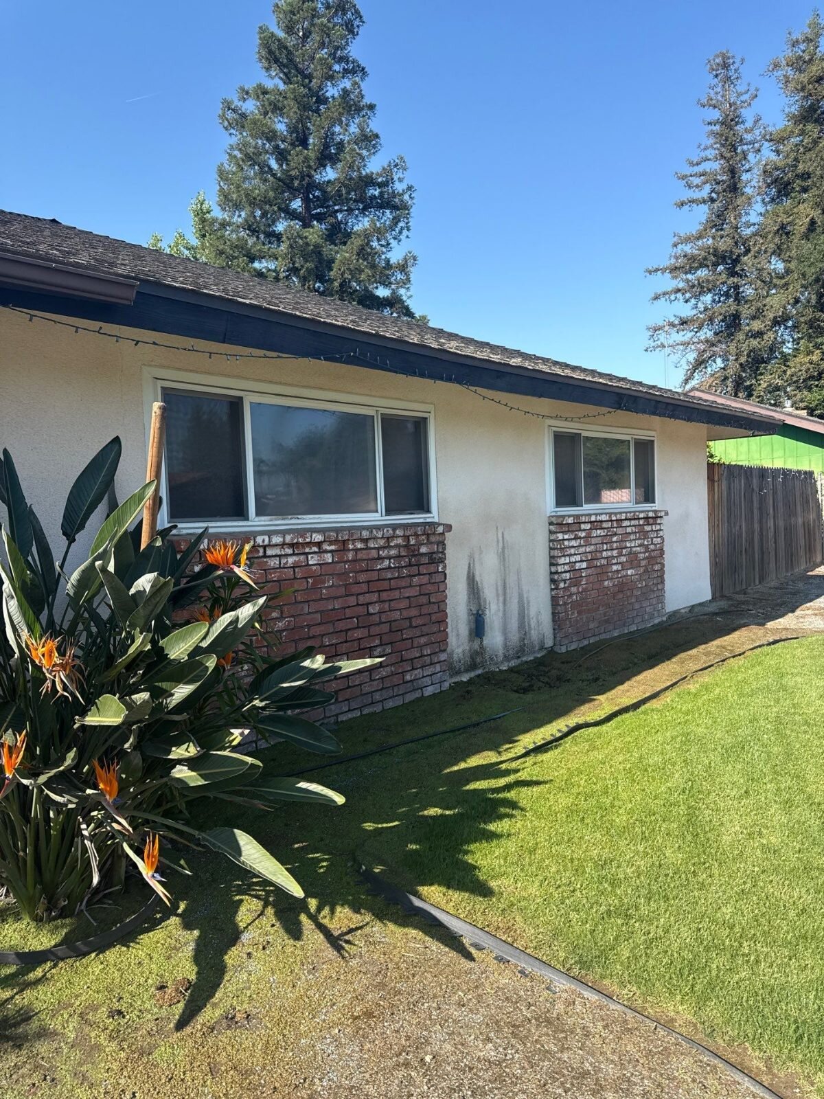 Central Valley ranch house with brick trim, the kind of house we buy as-is