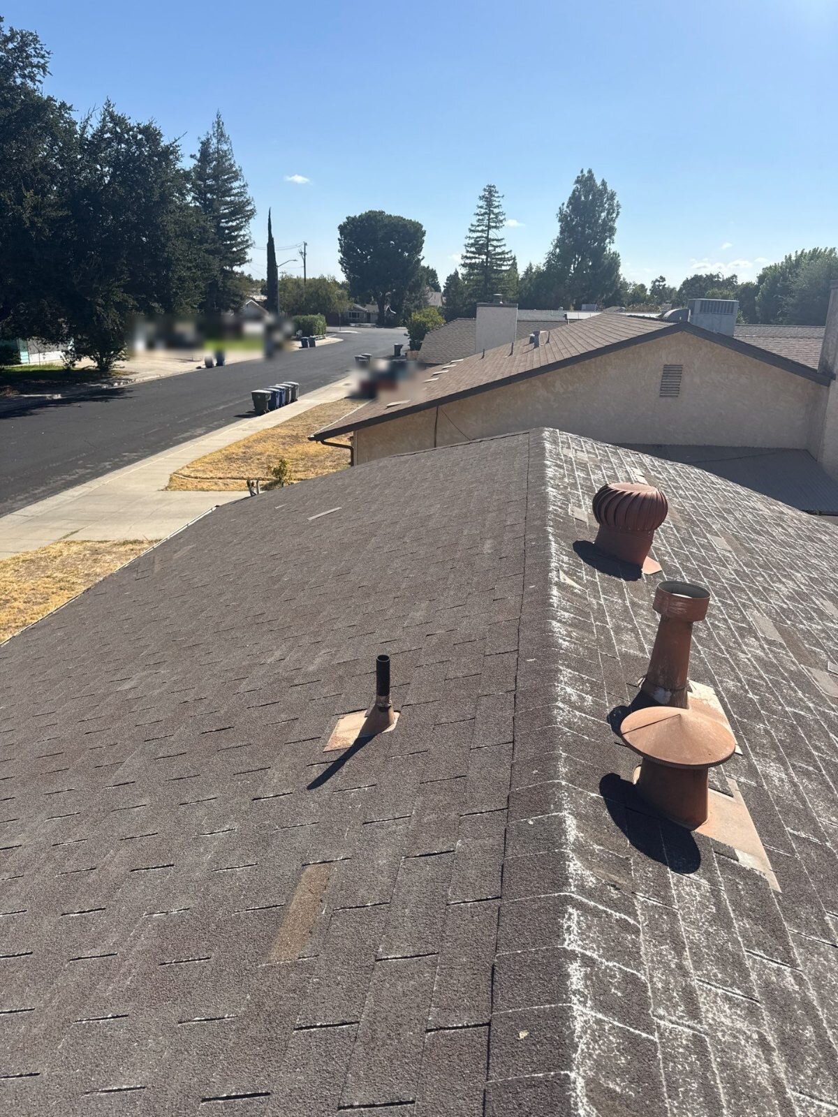 Worn composition roof with old vents on a Clovis house we bought
