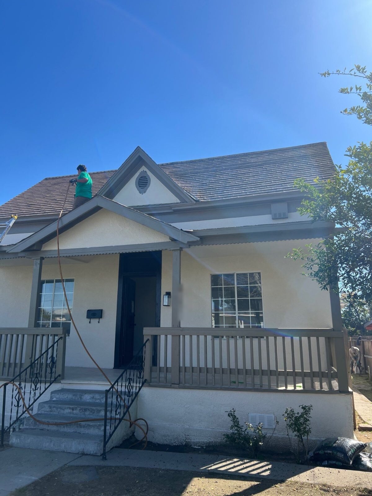 Fresno house we bought and renovated, with our roofer finishing the roof