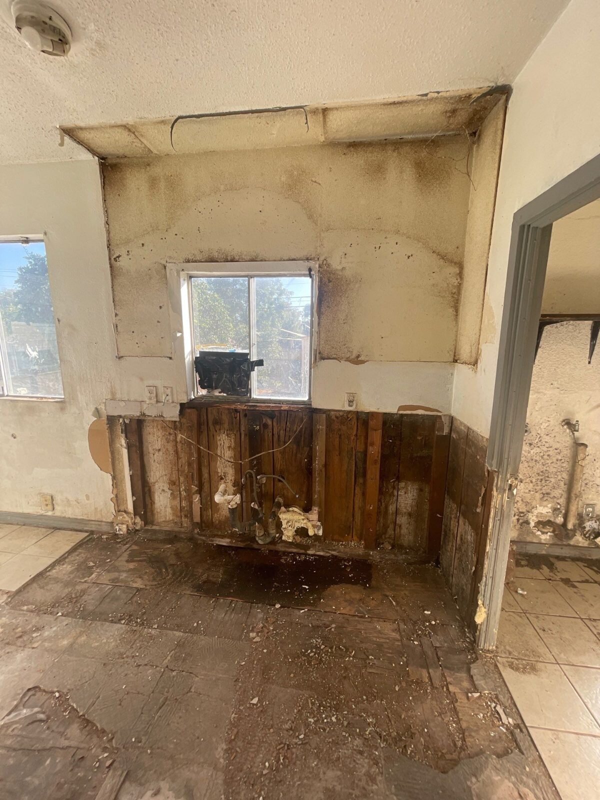 Fresno kitchen wall stripped to the studs before our renovation