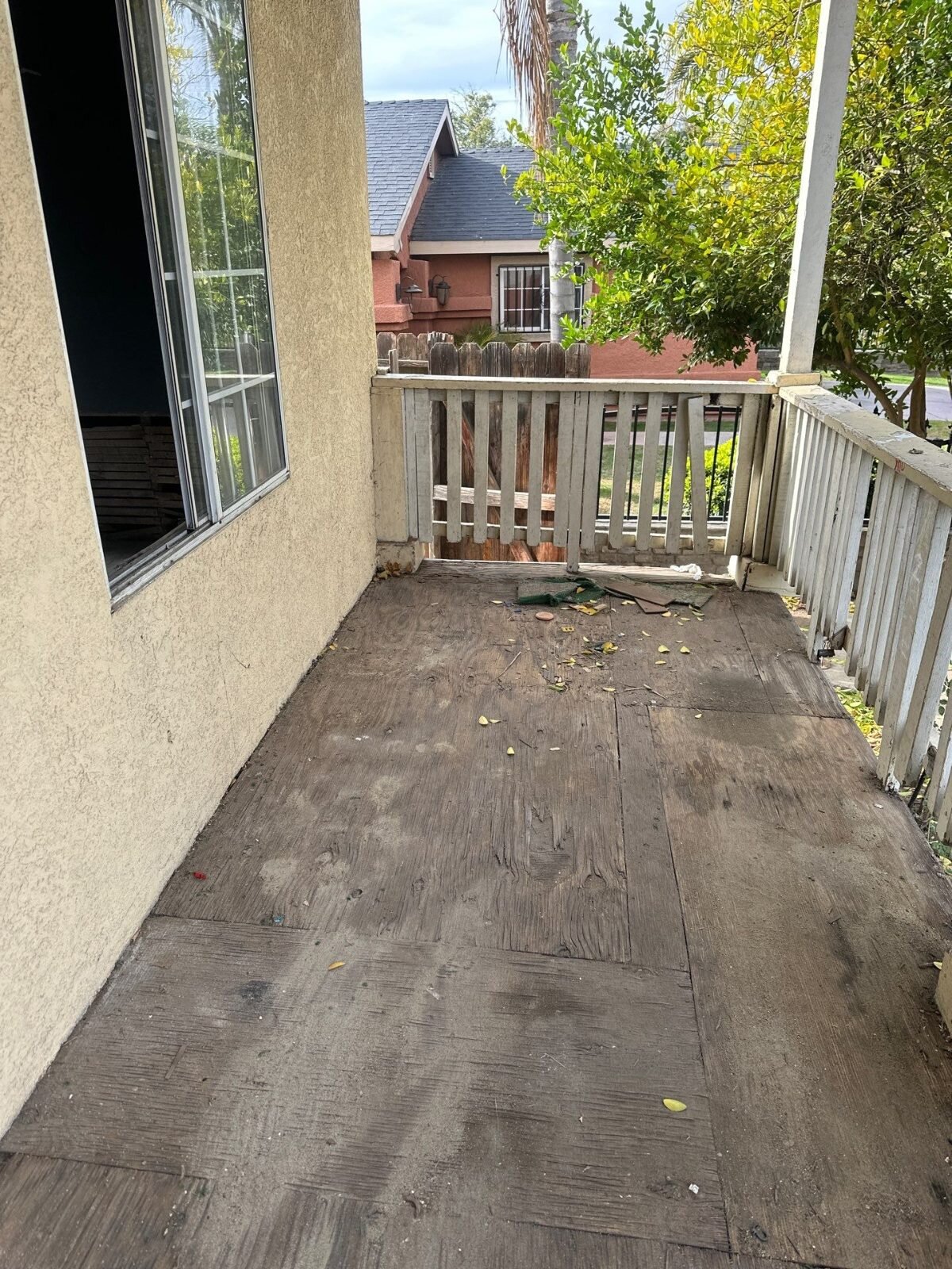 Worn porch floor on an older Fresno house before restoration