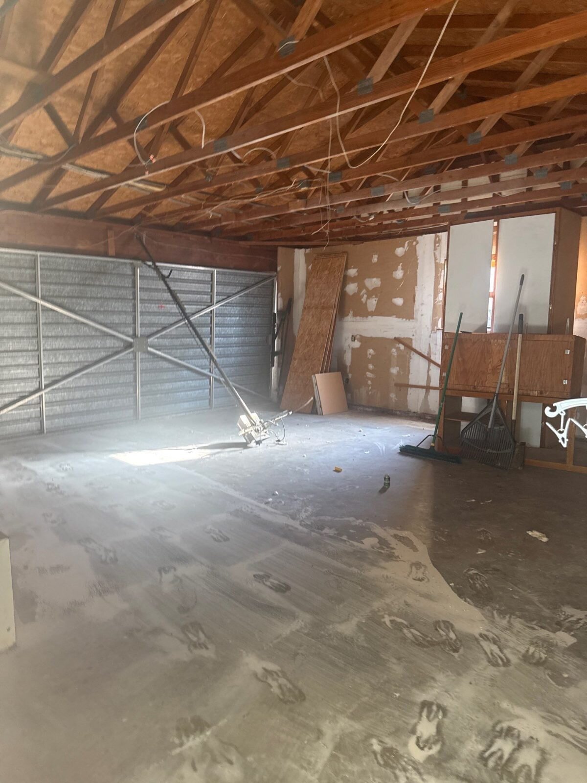 Garage stripped to the framing in a vacant Clovis house sold as-is