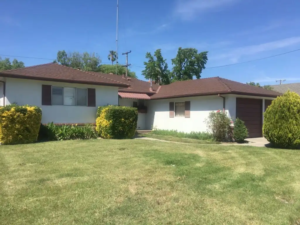 Single-story Sacramento home with a green front lawn, the kind of house Laurel Buys Houses buys for cash