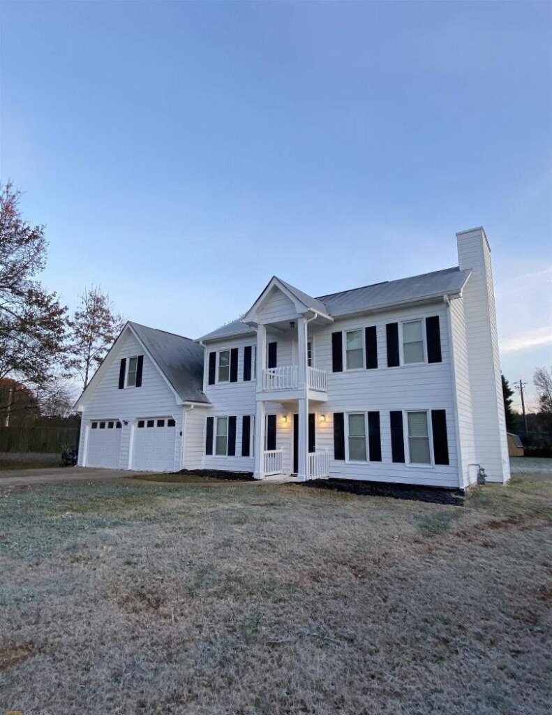 Front exterior of a two-story residential house on a sunny day.