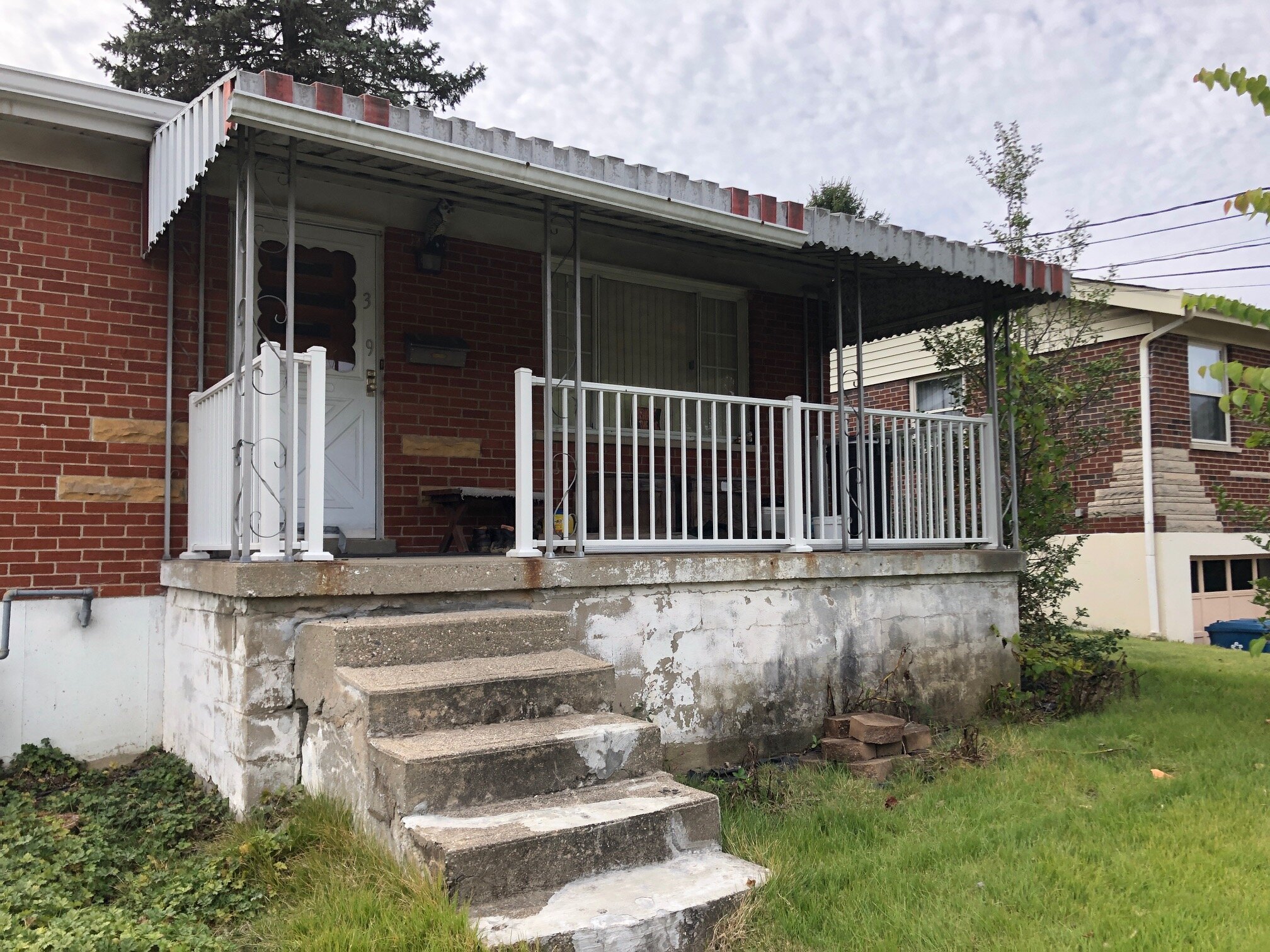 Landmark Home Buyers buys older homes that need repairs like this boarded up house