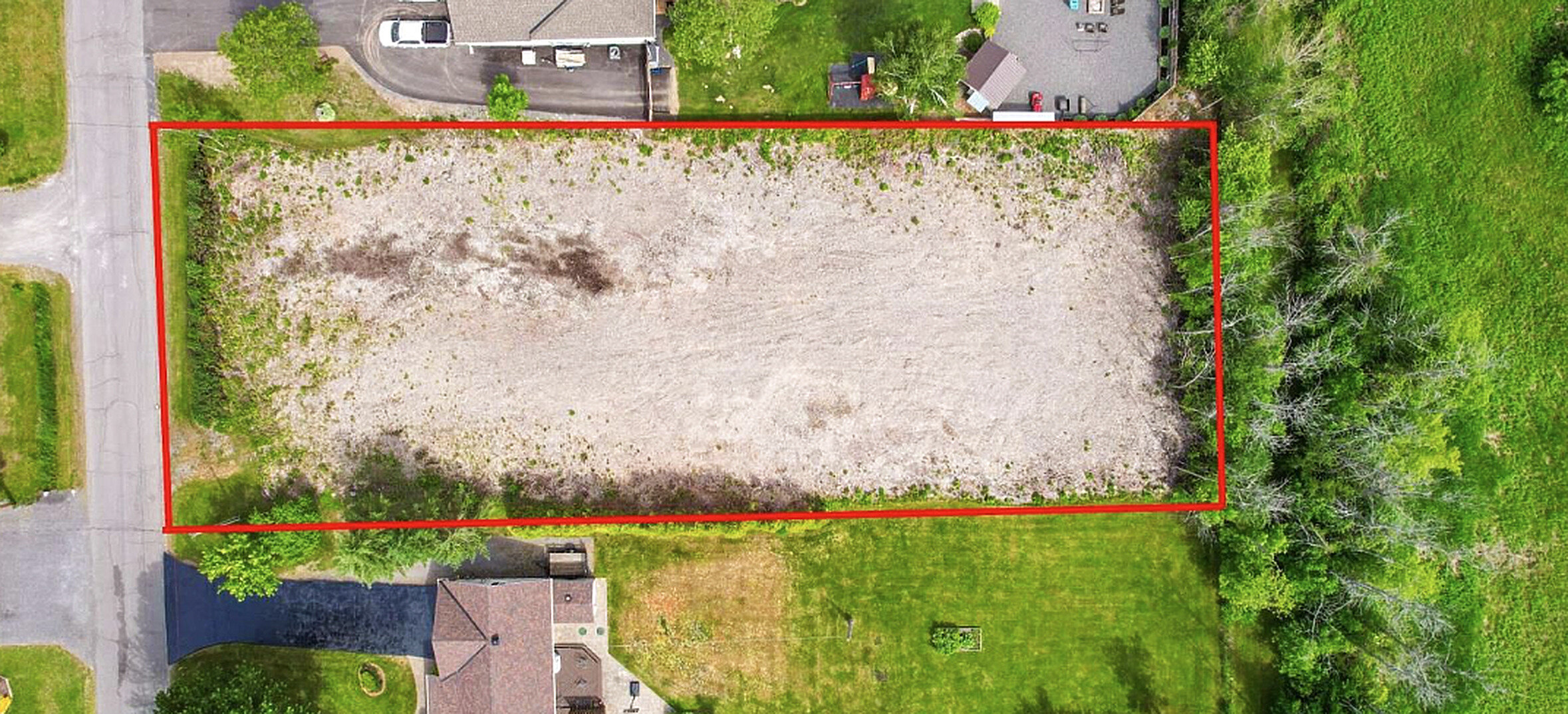 Aerial view of a cleared land parcel with boundary outline