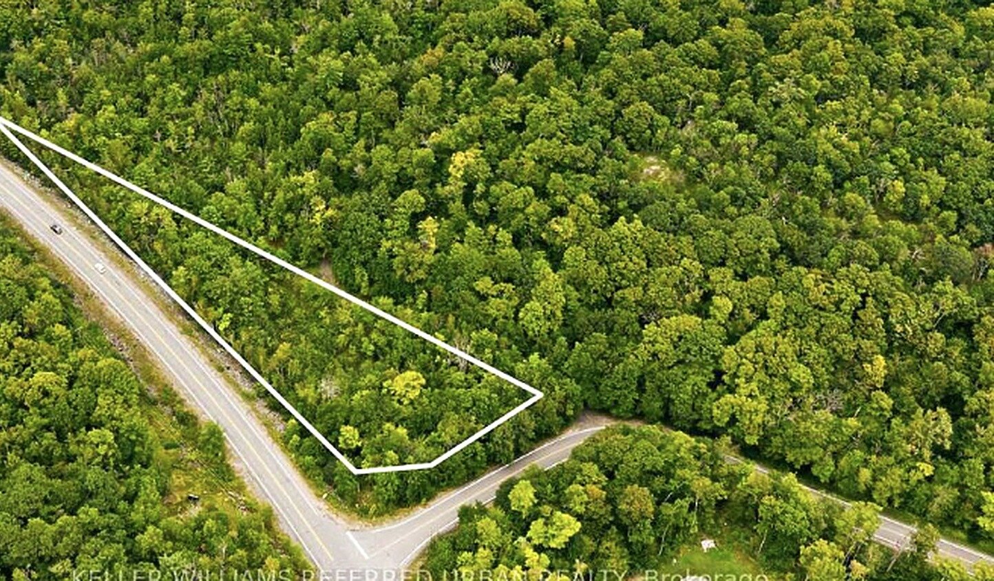 Aerial view of a forested land parcel with boundary outline in Canada