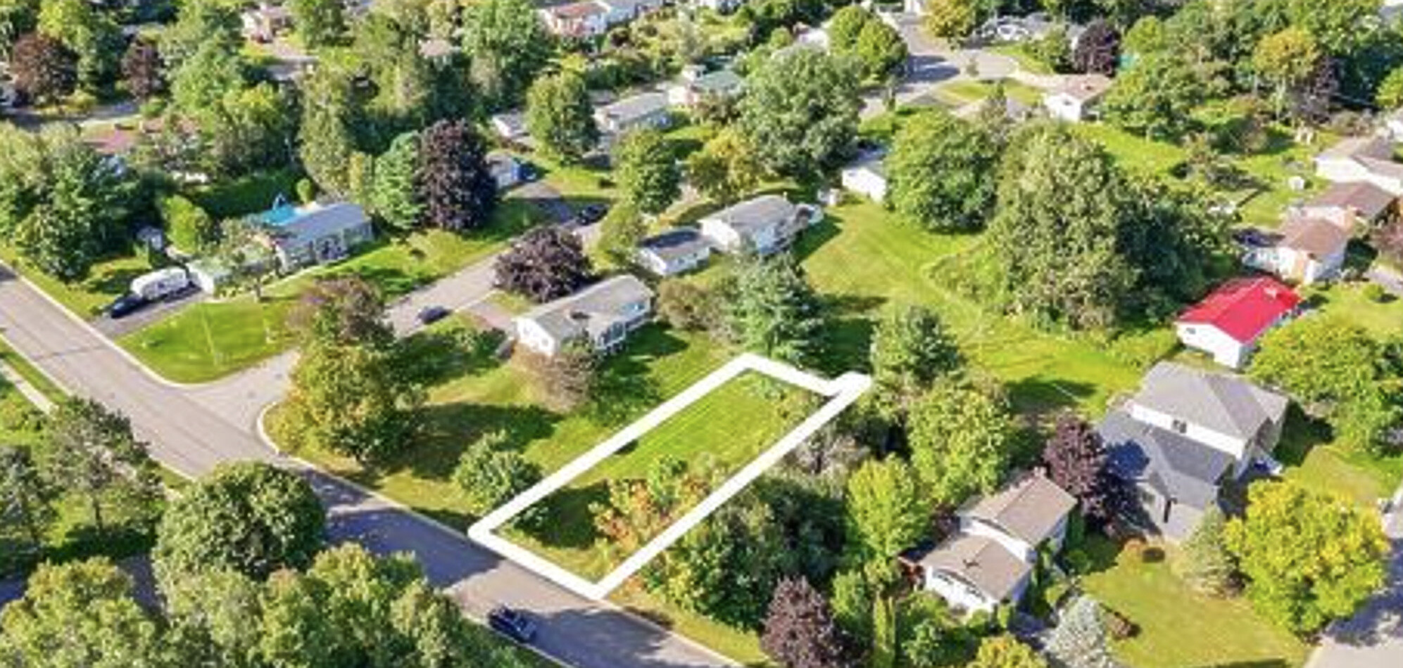 Aerial view of a vacant Alberta town lot with property boundary outline