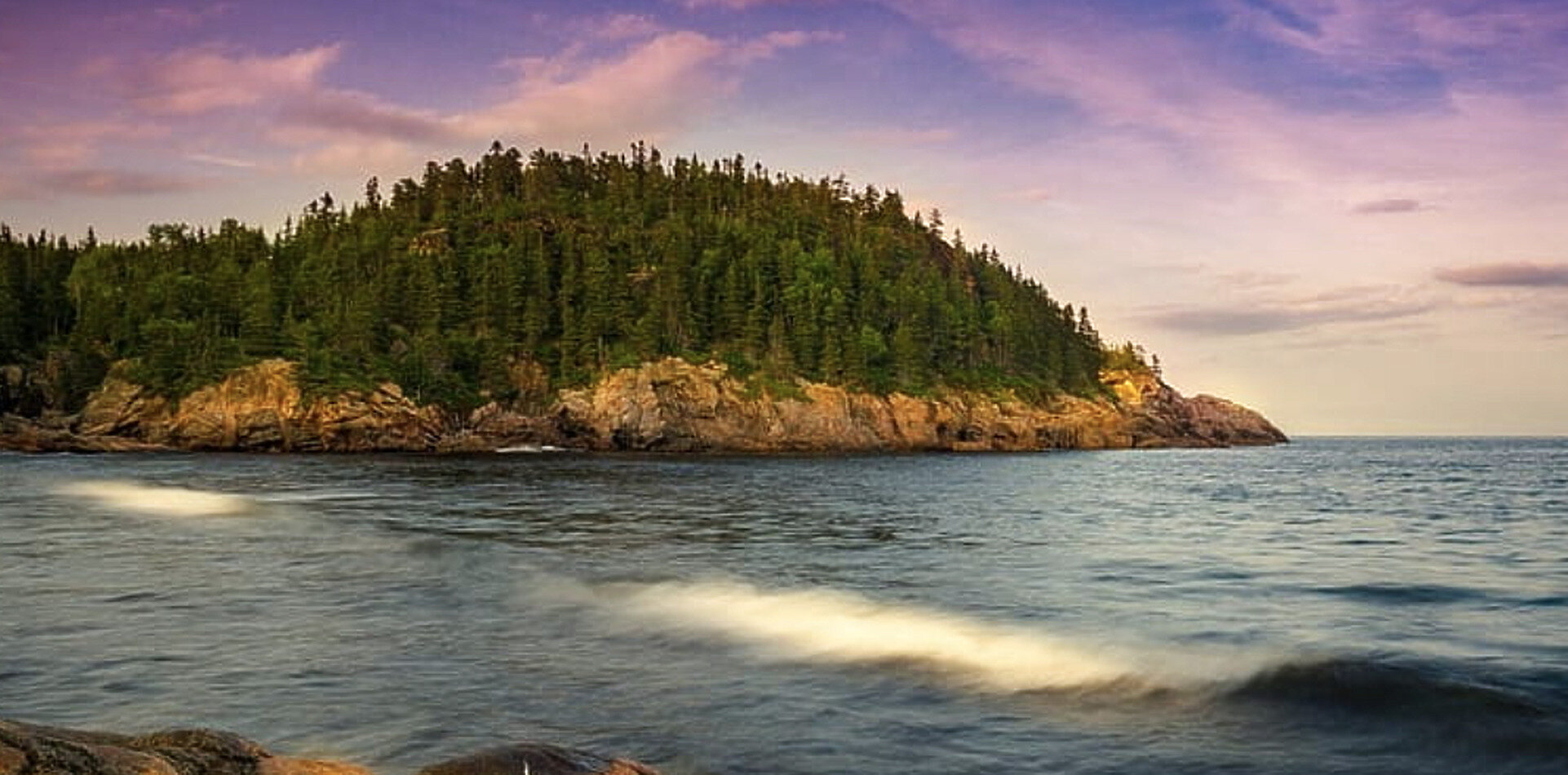 Forested headland meeting the sea in Cape Breton, Nova Scotia