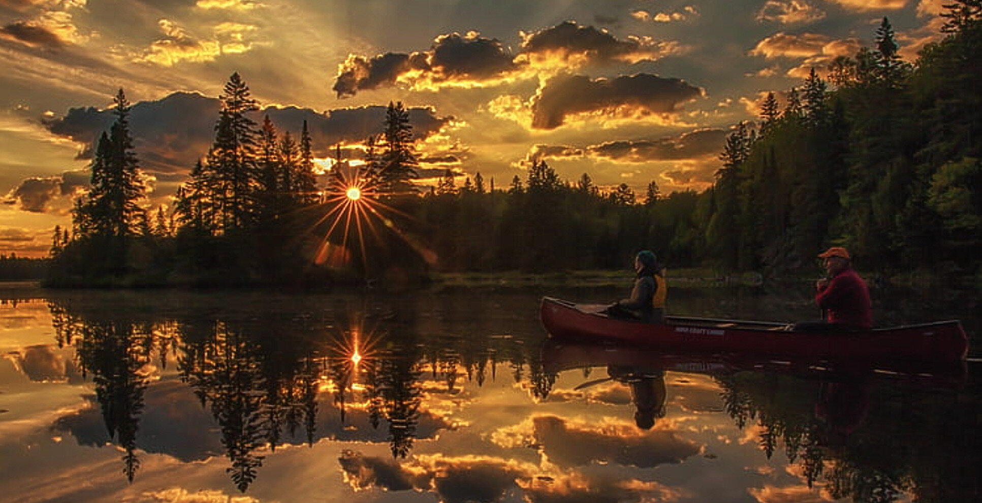 Canoe on a calm lake at sunset in Ontario