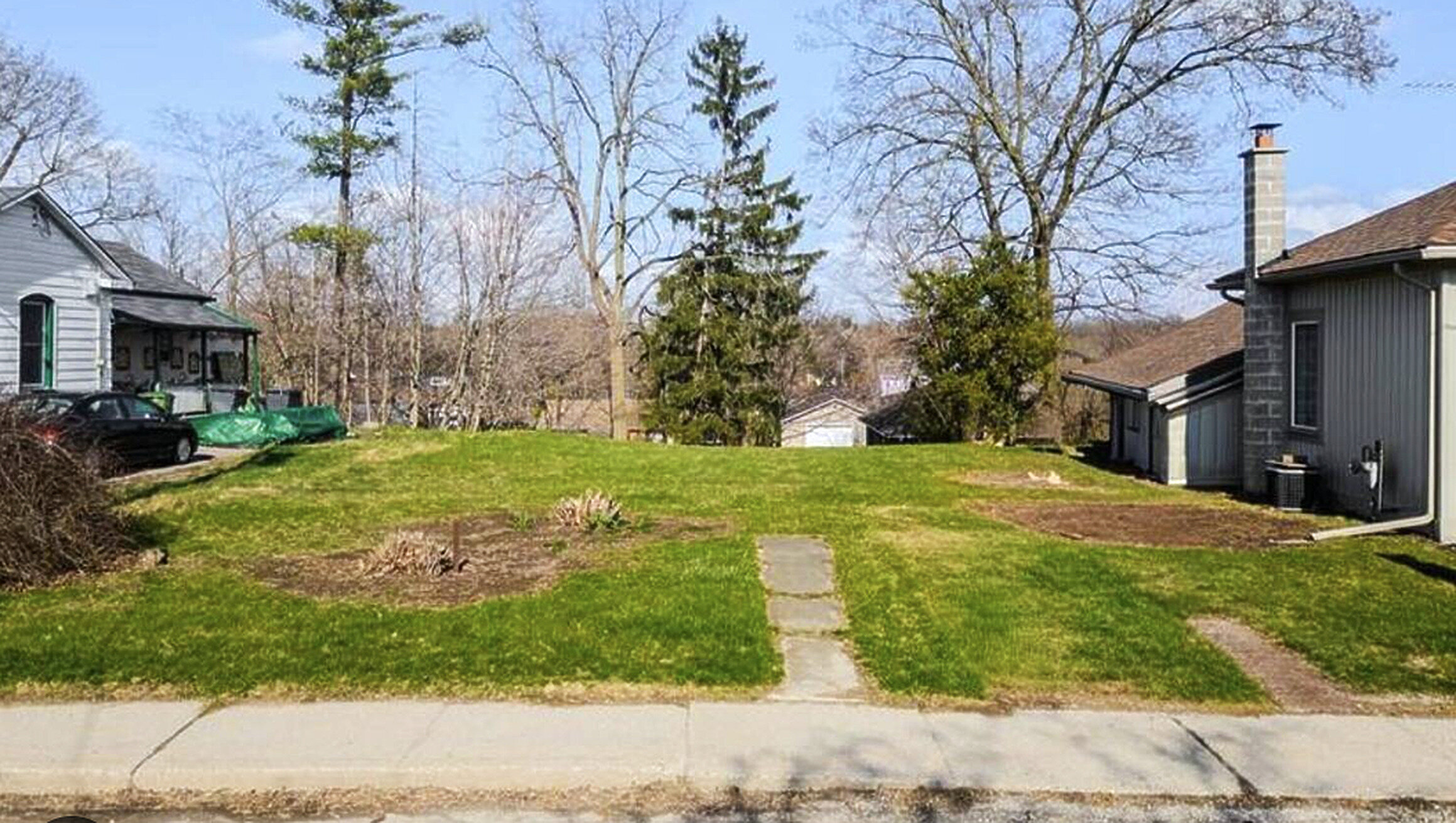 Vacant residential lot on an Alberta town street