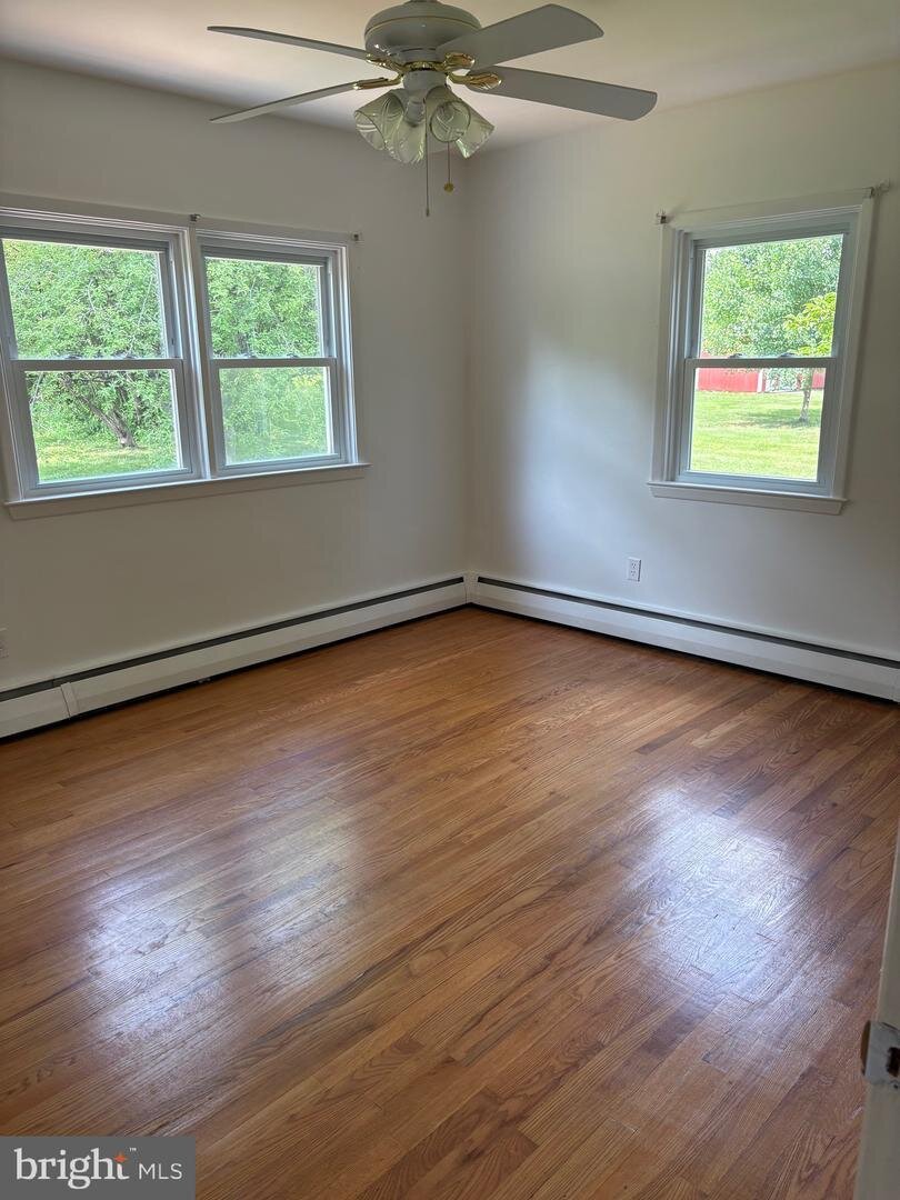 Bedroom with hardwood flooring at 1215 Milltown Road